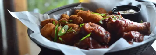 chicken wings and cheese curds in a basket