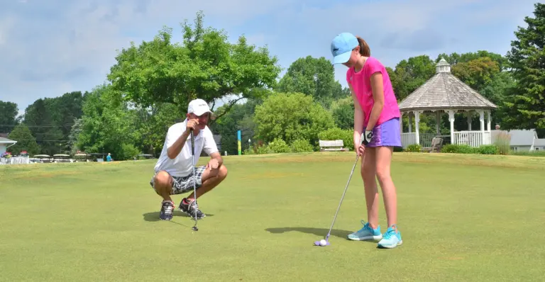 dad and daughter golfing