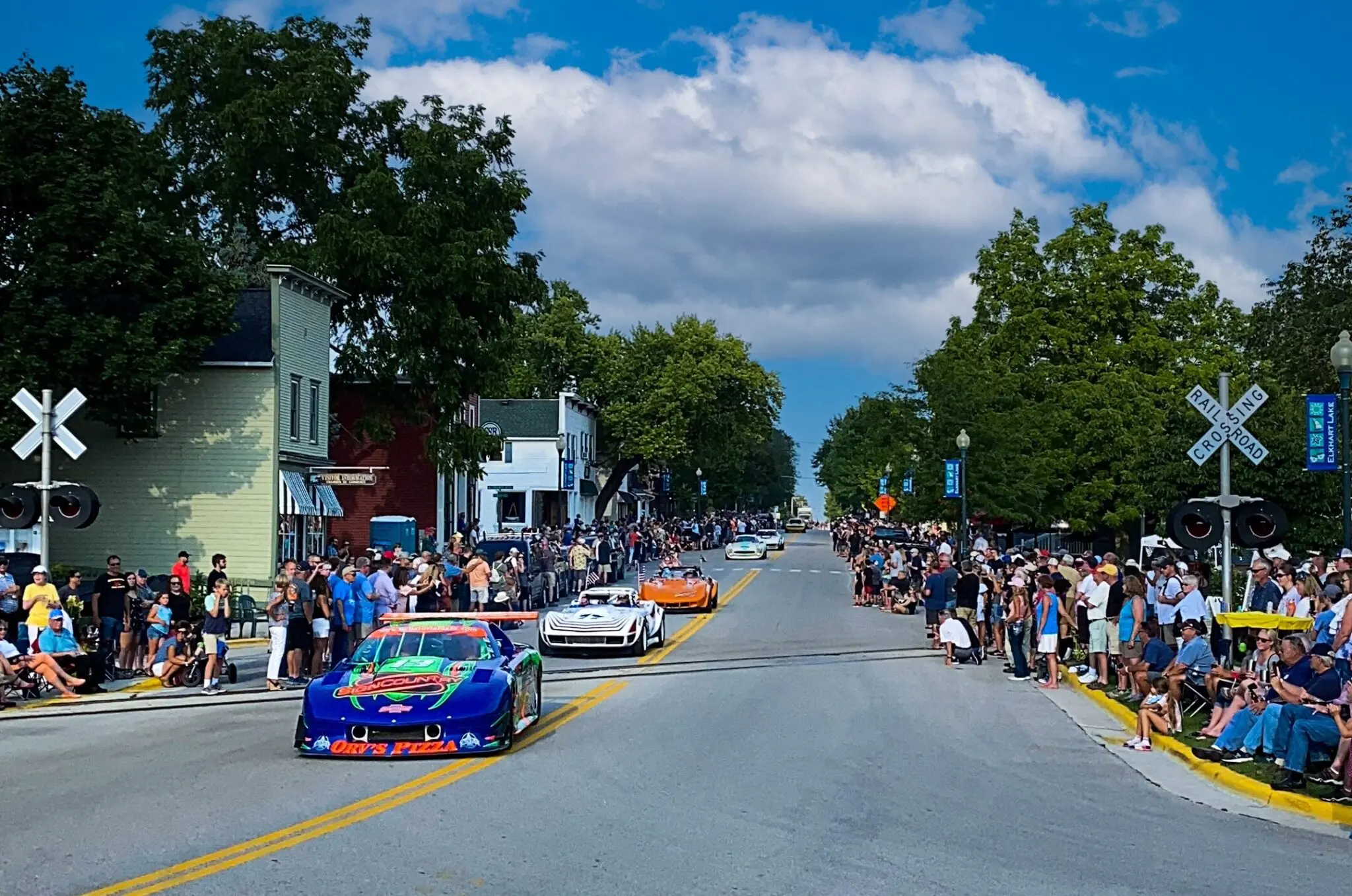 multiple racecars driving down road